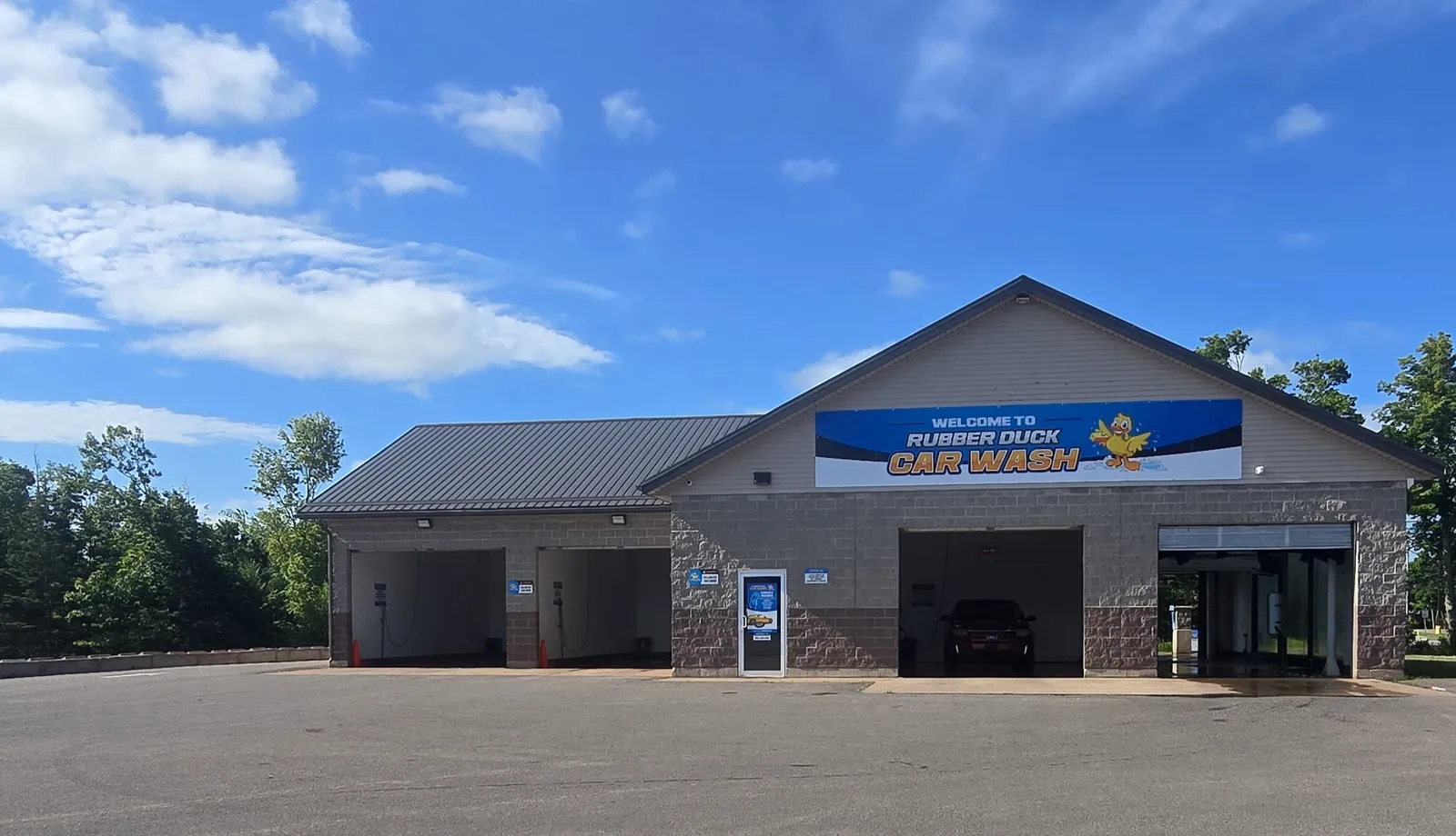 The Rubber Duck Car Wash building in Montague, with self-serve bays and an automatic wash bay under a blue sky